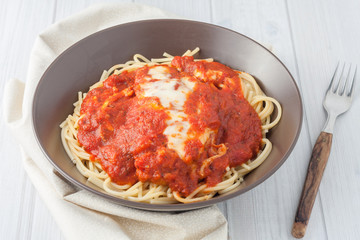 homemade breaded cutlet in tomato sauce and melted cheese over