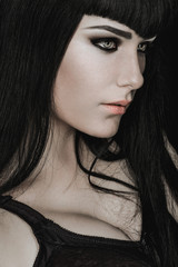 Portrait of a pale gothic woman in black