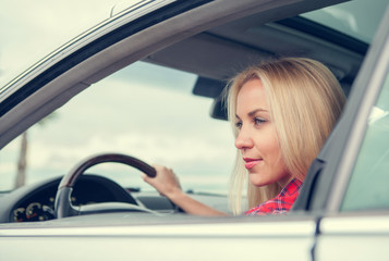 Fototapeta na wymiar Young woman drive a car