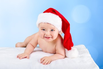 Infant. Little cute girl with santa hat on blue background