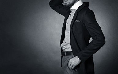 Stylish man in an elegant suit. - obrazy, fototapety, plakaty