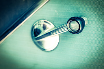closeup of old mirror handle controller of vintage car