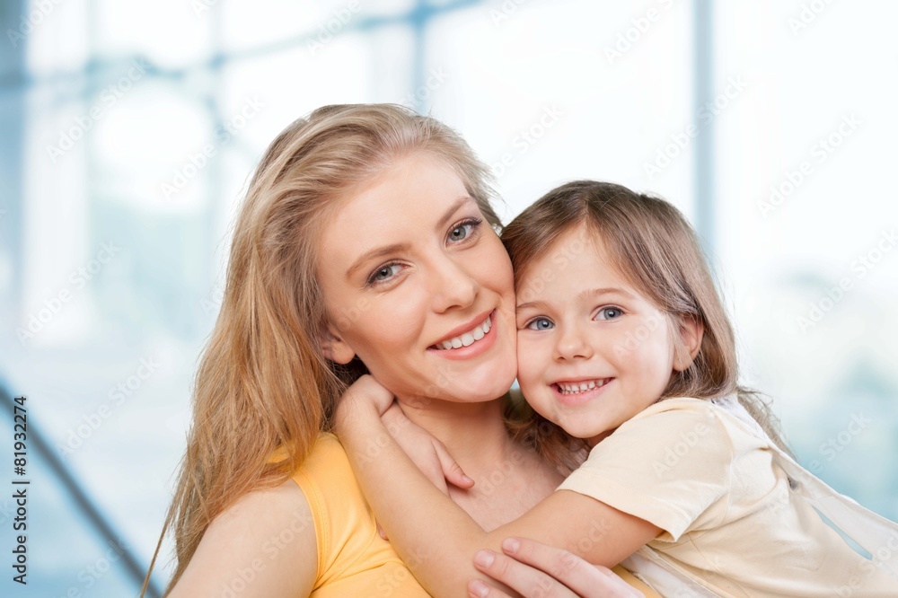 Wall mural Mom. CLoseup portrait of happy  white mother and young daughter