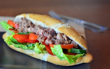 Tuna Baguette With Vegetables On The Brown Plate
