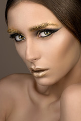 Fototapeta premium Beauty woman with gold make-up