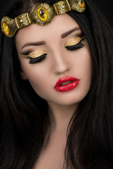 Sexy fashion model with makeup in golden crown on head