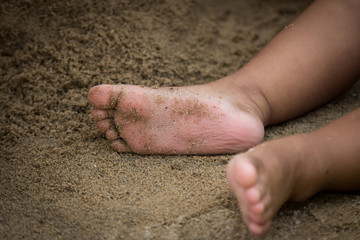 little girl's feet in sand