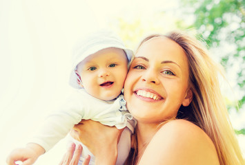 happy mother with little baby outdoors