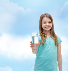 smiling little girl giving glass of water