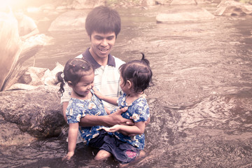 Vintage color style of father and two little girls having fun to