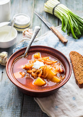 red borscht with sour cream, wild garlic, black bread, rustic