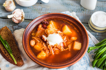 red borsch with beans, sour cream, wild garlic, rye bread, rusti