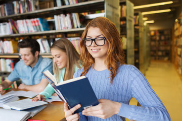 happy students reading books in library