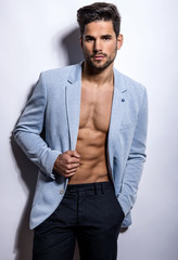 handsome young bodybuilder showing of his fit body and muscles