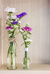 Flowers in the glass bottles decorated living room