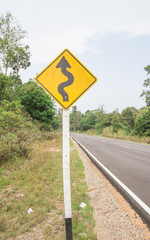 Curvy road sign to the mountain in rural area