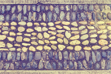 pebbles arranged on the wall vintage color