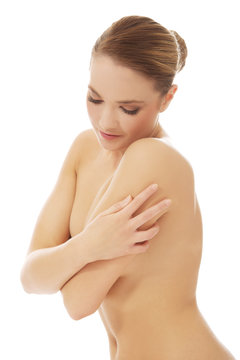 Beautiful spa woman covering her breast.