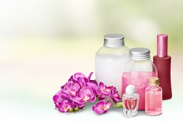 Fototapeta na wymiar Cosmetics. Pink soap bottles and flowers