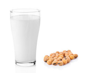 fresh milk in the glass with soy beans on white background