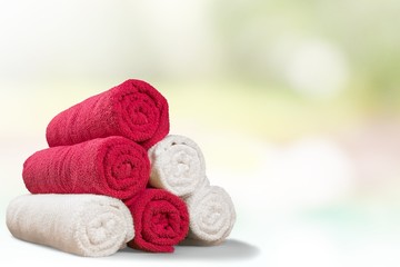 Obraz na płótnie Canvas Towel. Five rolled multicoloured bath towels isolated on white