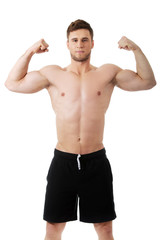 Fototapeta premium Young athletic man showing his muscles.