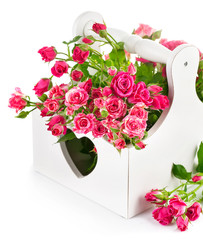 bouquet pink roses in wooden basket isolated on white background