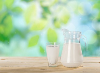 Milk. Milk on table and sunny trees