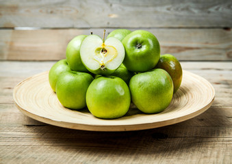 fruit. apples in a bowl on wooden background