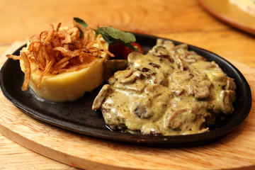 Plate of pork chops baked with onions