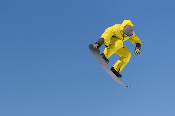 Snowboarder jumps in Snow Park