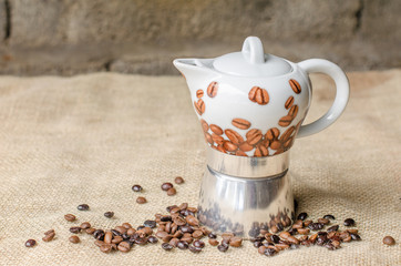 Coffee pot on rustic background.
