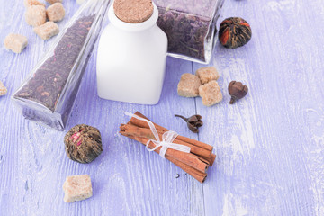 Fototapeta na wymiar dry tea leaves cinnamon and on wooden background