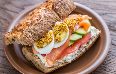 Sandwich with salmon, avocado and eggs