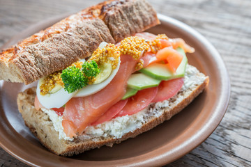 Sandwich with salmon, avocado and eggs