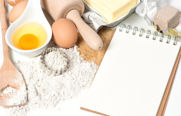 Recipe book and baking ingredients. Food background