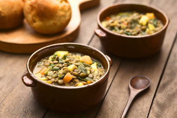 Vegetarian soup made of lentils, spinach, potato, carrot, onion