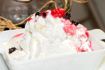Homemade ice cream with whipped cream and berries, dessert Italy