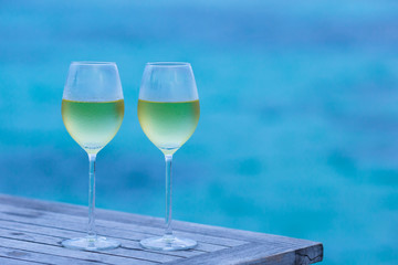 Two glasses of tasty white wine at sunset