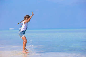 Adorable happy smiling little girl have fun on beach vacation