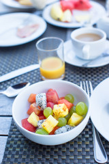 Fresh fruit salad, coffee with milk and juice served for