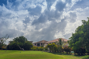 Fototapeta na wymiar Golf course in Dominican republic. field of grass and coconut