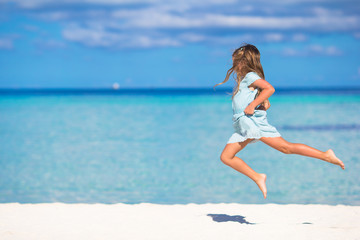 Adorable little girl during beach vacation having fun