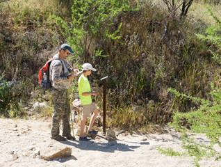 Father and son looking at a map and think and pointers on where