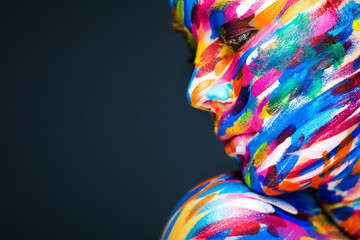 Portrait of the bright beautiful girl with art colorful make-up