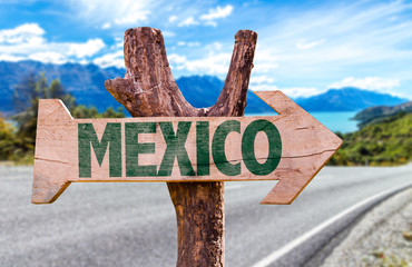 Mexico wooden sign with road background