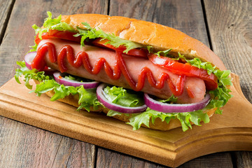 Hot dog with tomato and lettuce