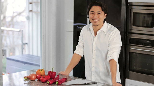 Young masterchef in kitchen with vegetables