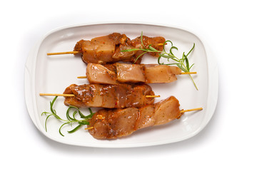 Raw chicken kebab on white background.