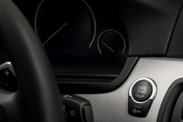 Modern car engine start and stop button. Interior detail.